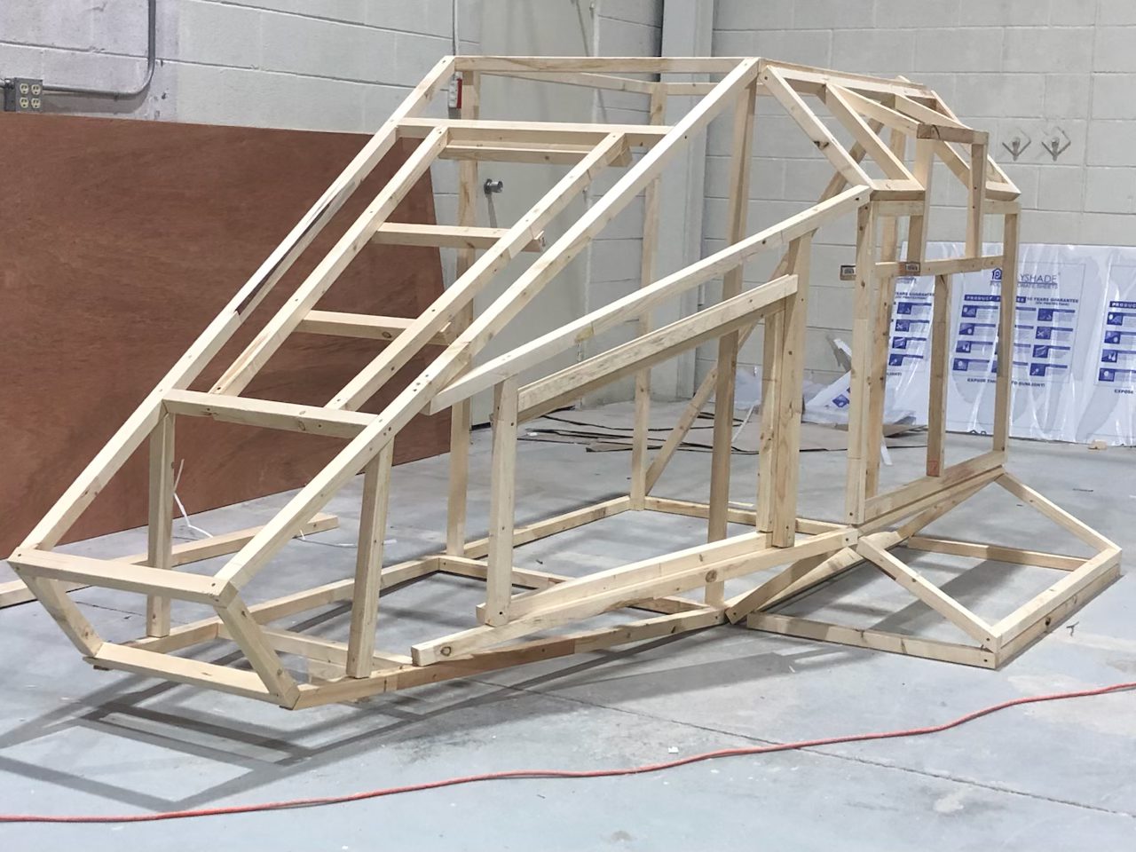 The bare wooden frame of the Memory Keeper pod in the shop